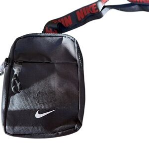 Nike crossbody black and red with pockets.  Zip around